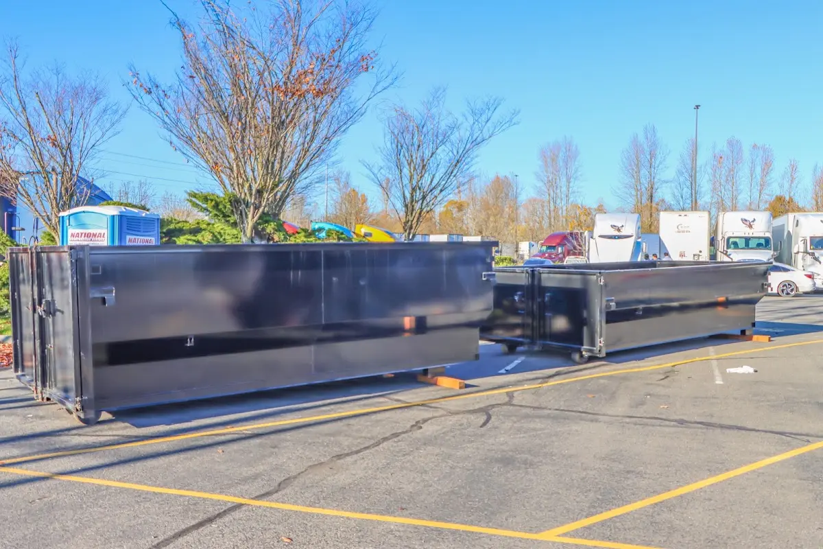 Professional dumpster rental service with roll-off container on residential driveway in Bennettsville